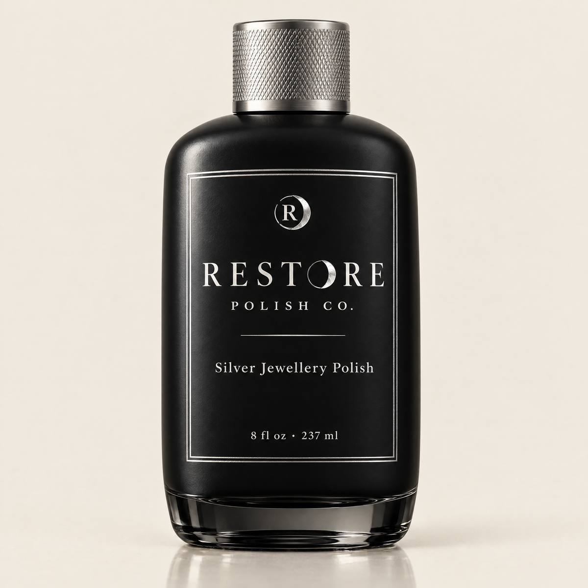 Restore Polish Co. silver jewellery polish in a heavy black glass bottle with a knurled silver cap
