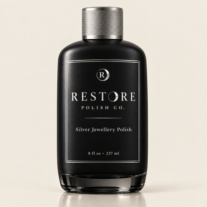 Restore Polish Co. silver jewellery polish in a heavy black glass bottle with a knurled silver cap